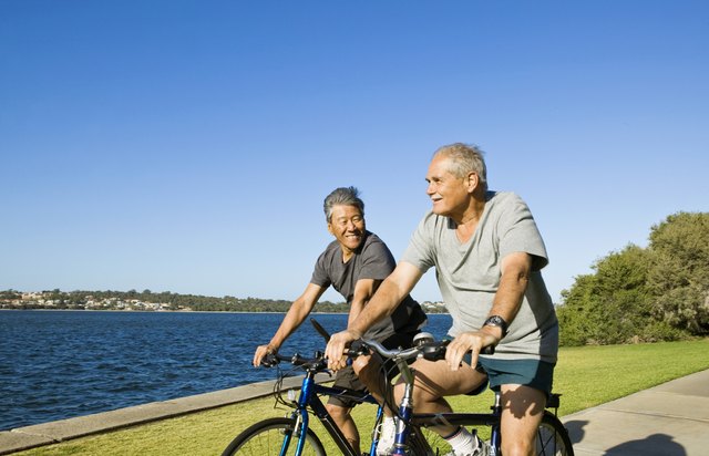 Men riding bikes by lake