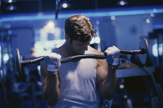 Young man exercising with barbells