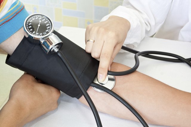 doctor measures pressure in the patient