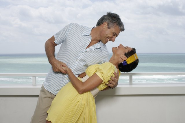 Couple dancing with sea in background