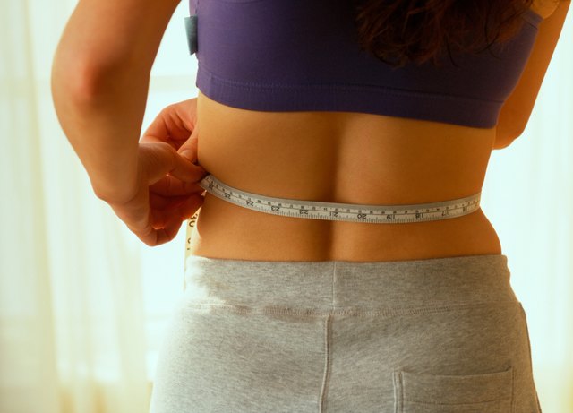 Woman measuring her waist