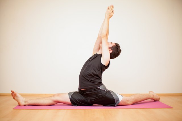 Young man doing a leg split
