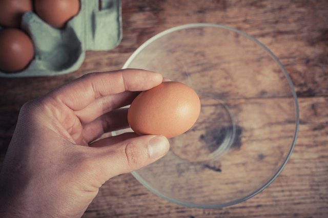 Hand cracking egg