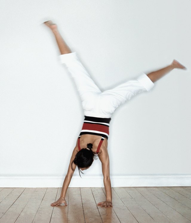 Woman doing cartwheel in studio