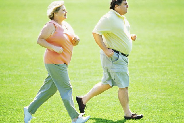 side profile of a mature couple jogging in the park