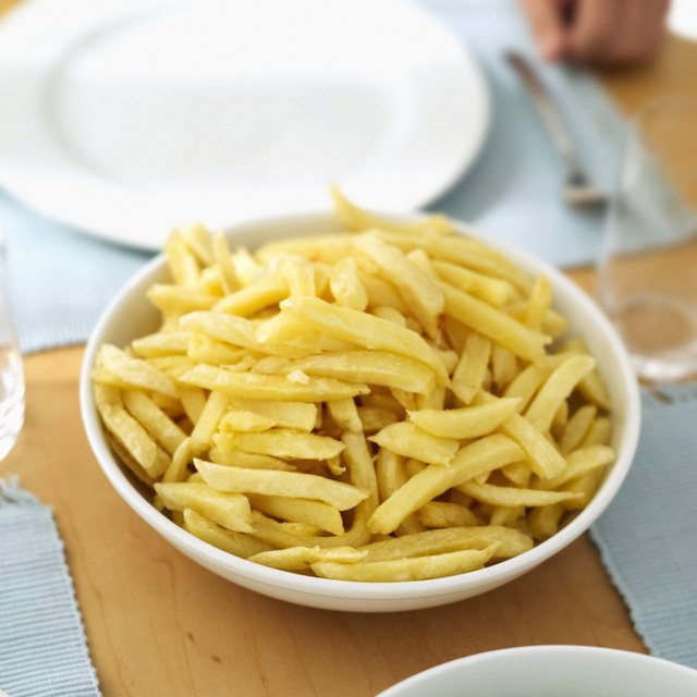 Close-up of a bowl of French fries on a table