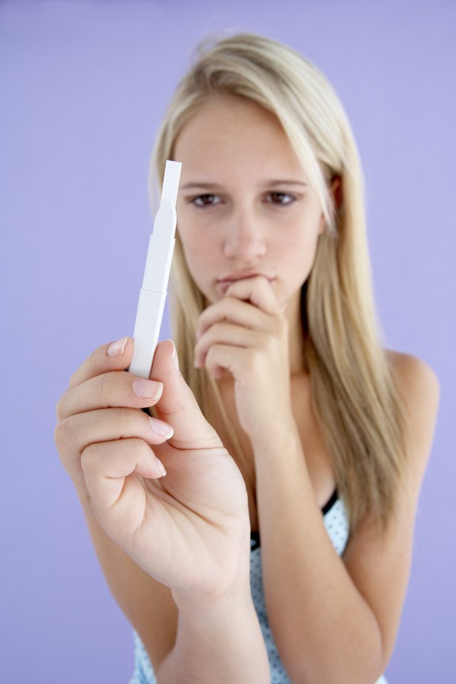 Girl holding pregnancy test