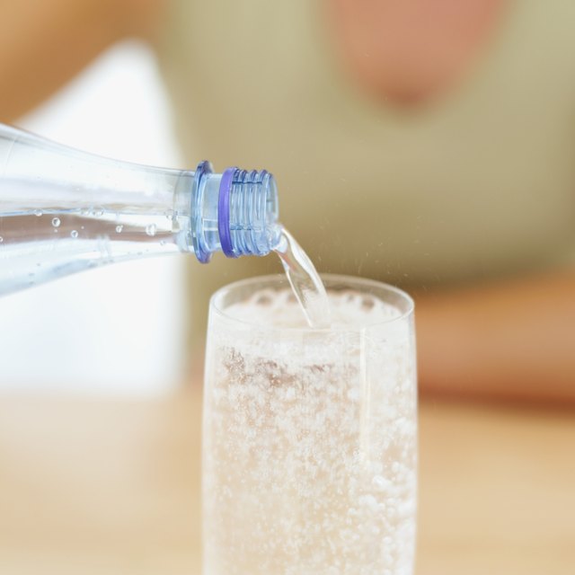 close-up of soda being poured from a bottle into a glass