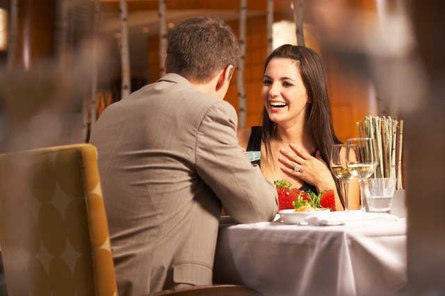 Woman receiving gift from man in restaurant