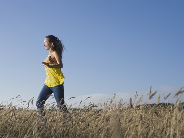 Hispanic woman walking in field