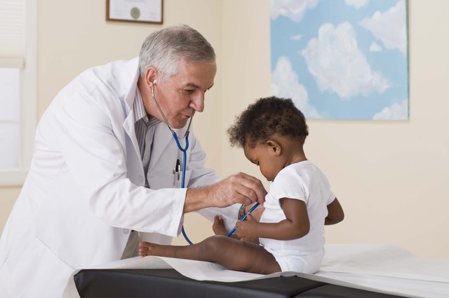 Doctor listening to toddlers heart