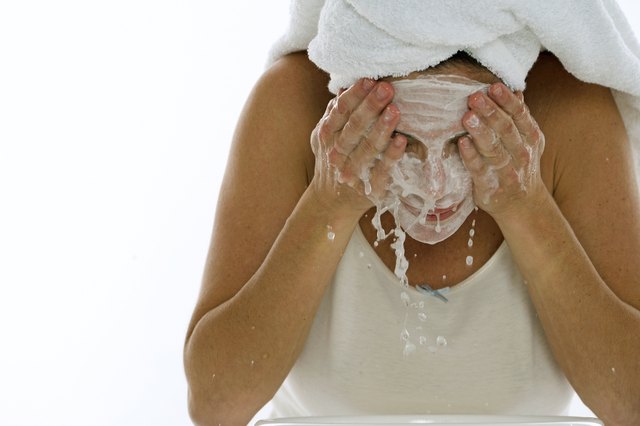 Young woman splashing water on her face