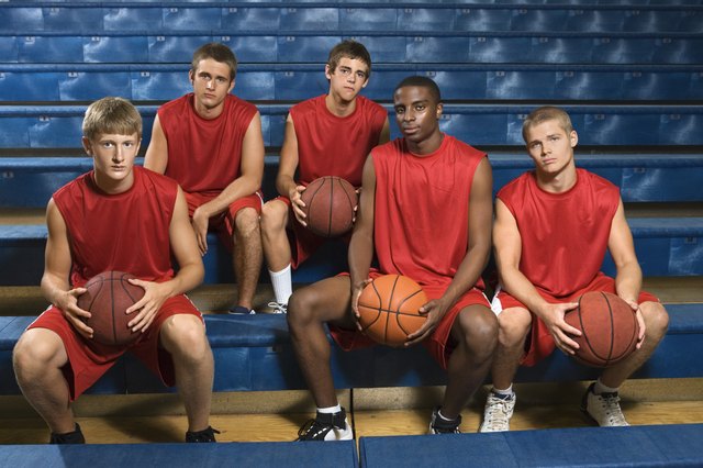 Basketball team sitting in bleachers
