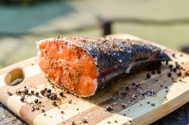 Prepared peace of fresh salmon fish with salt and pepper