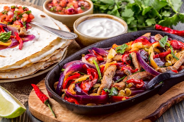 Pork fajitas with onions and colored pepper, served with tortill