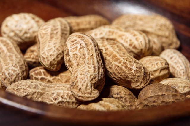 Peanuts in wooden dish closeup macro