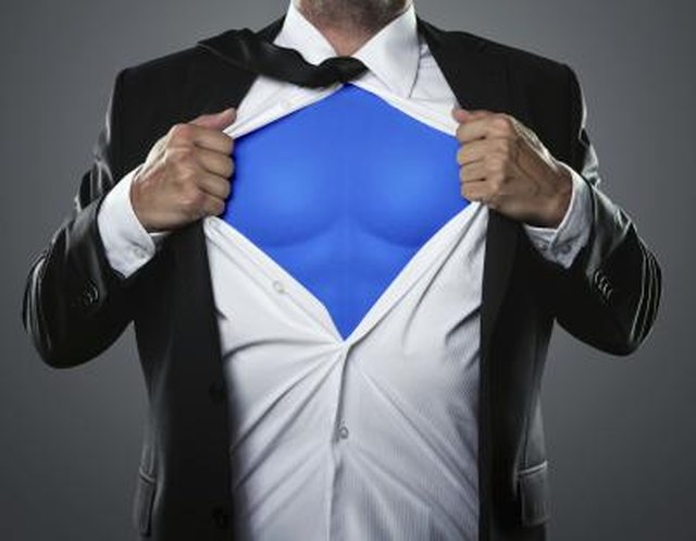 Young businessman acting like a super hero and tearing his shirt off with copy space