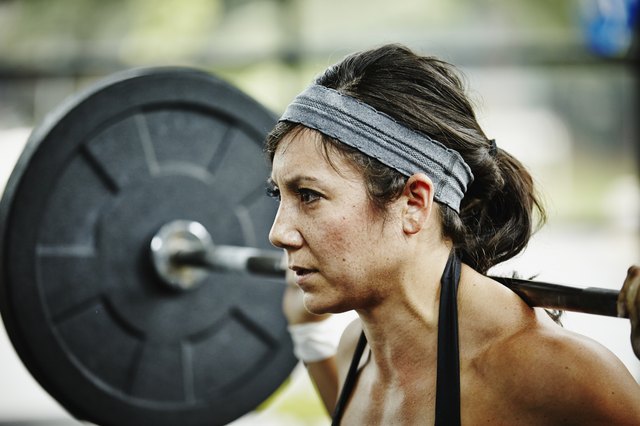 Woman preparing to press barbell overhead