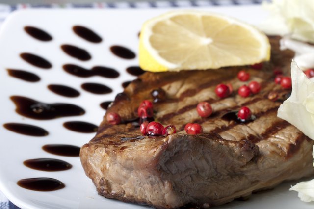 slice of grilled rump steak with green and pink pepper