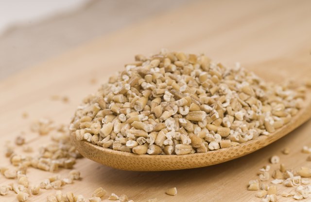 Steel cut oats on a wooden spoon