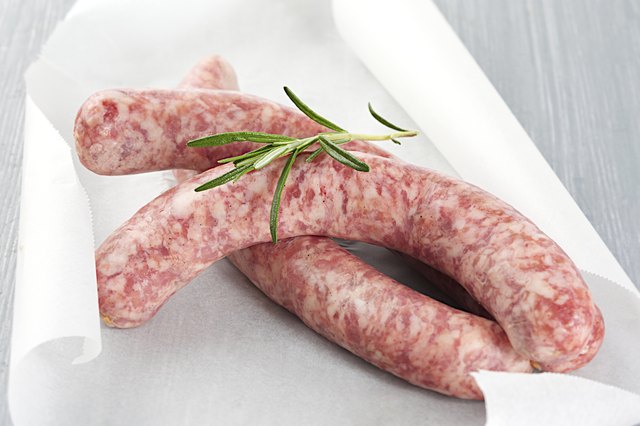 Raw sausages chipolata with herbs