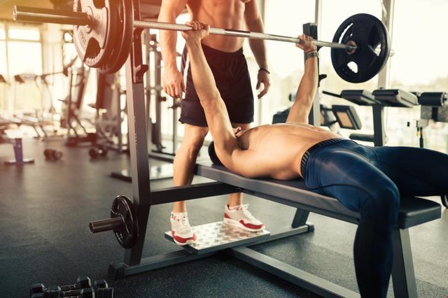Muscular bodybuilder bench press workout