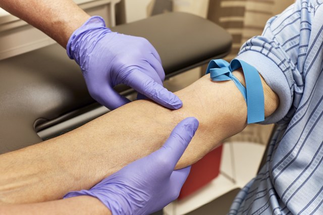 Technician prepping a patient for a blood test
