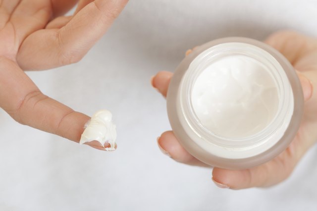 Skin care. Girl applying moisturizing cream.