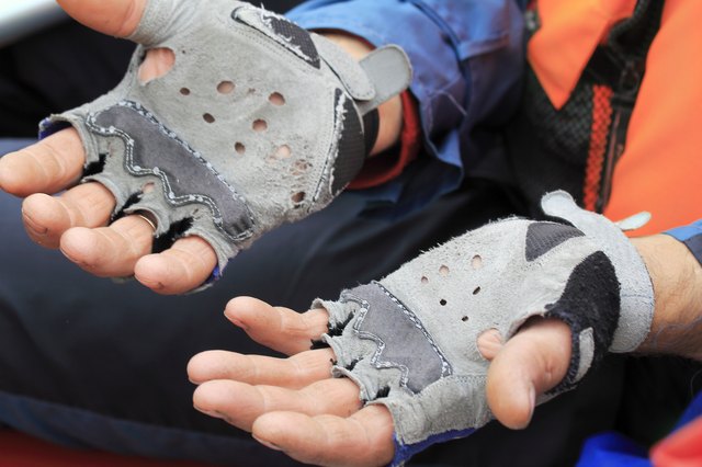 The hands of travelers in worn leather gloves