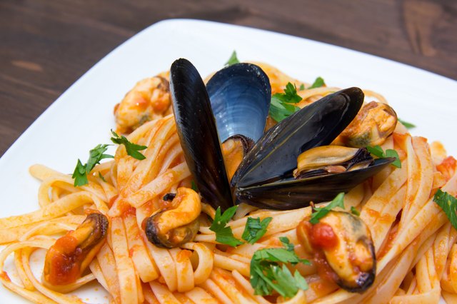 Pasta with mussels on wooden close