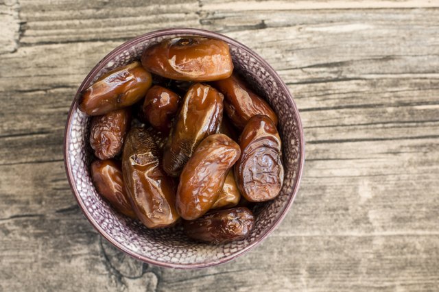 Bowl of dates on wood