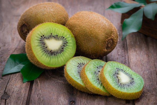 Kiwi fruit slices on wooden table
