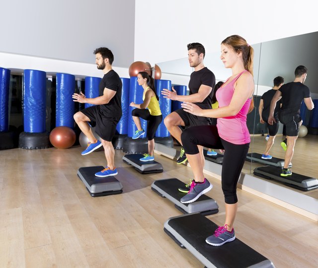 Cardio step dance group at fitness gym training