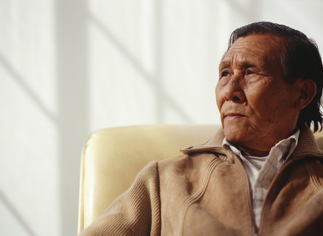 Senior man sitting indoors in armchair