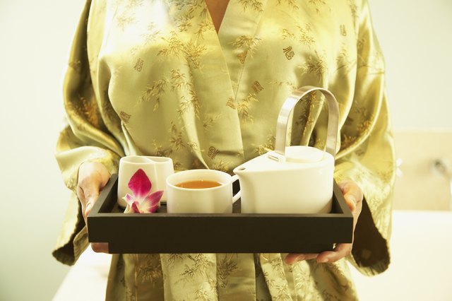 African American woman carrying tea tray