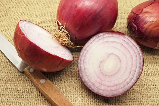 Whole and Sliced Red Onions on Burlap
