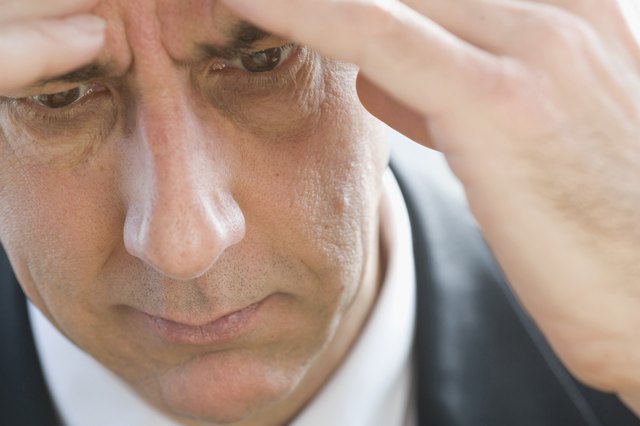 Close-up of businessman touching forehead