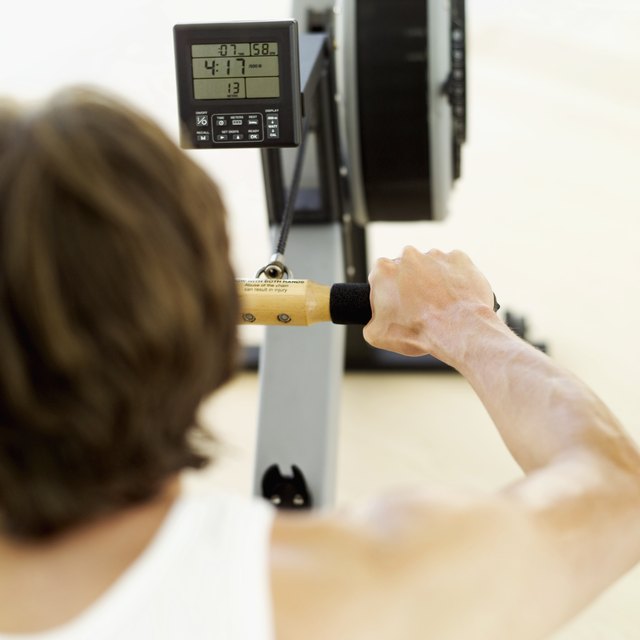 rear view of a young man exercising on a rowing machine