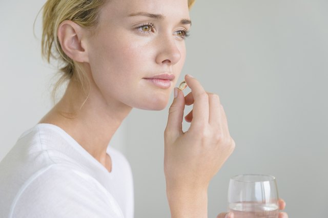 Woman taking an Omega-3 capsule
