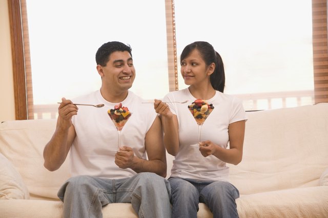 Hispanic couple eating fruit salad