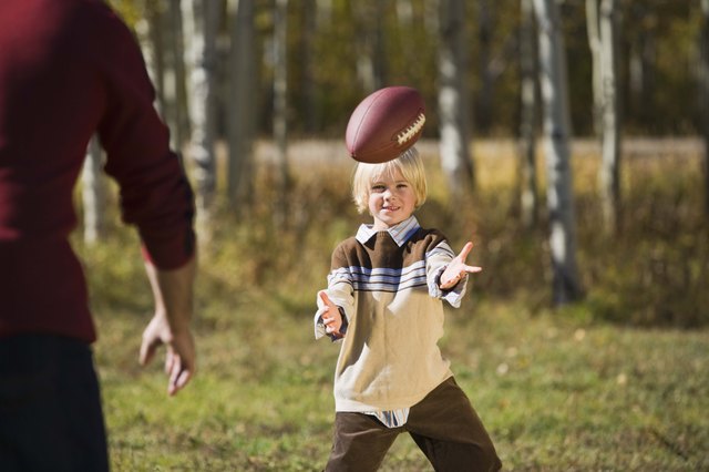 Father and son playing football