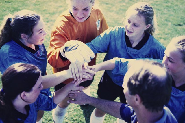 High angle view of a girl's soccer team in a huddle