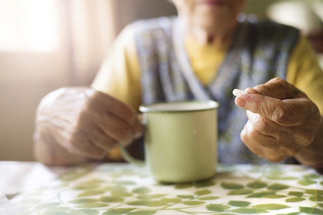 Old woman taking pills