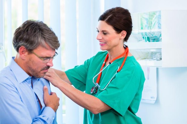 Orthopedist doctor examining shoulder of patient in surgery