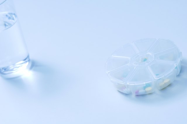 Glass of water and pill case