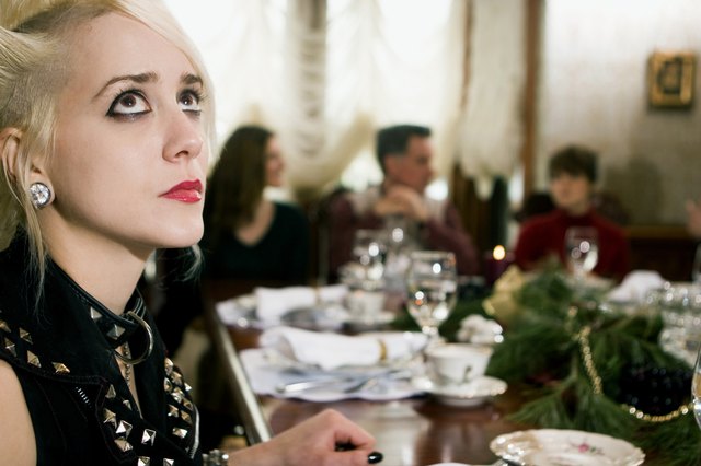 Young woman looking up at dining table