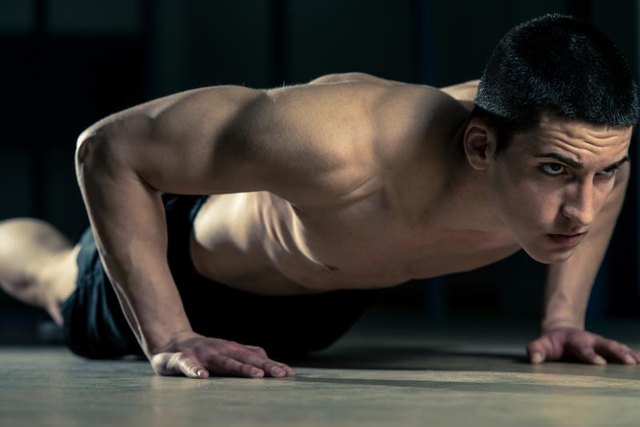 Young Athlete Doing Push-Ups As Part Of gym Training