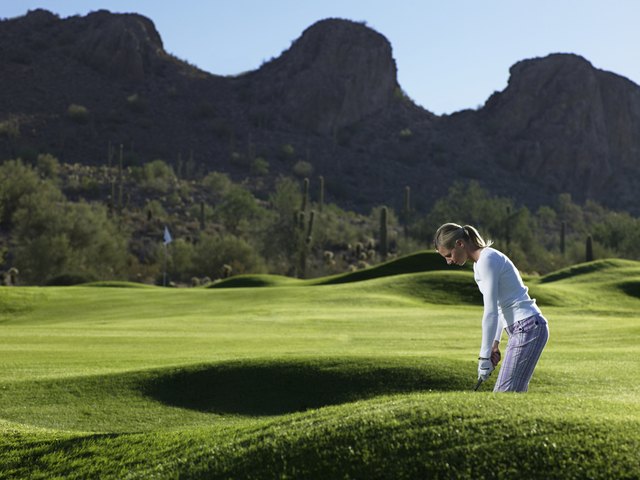 Woman playing golf on course