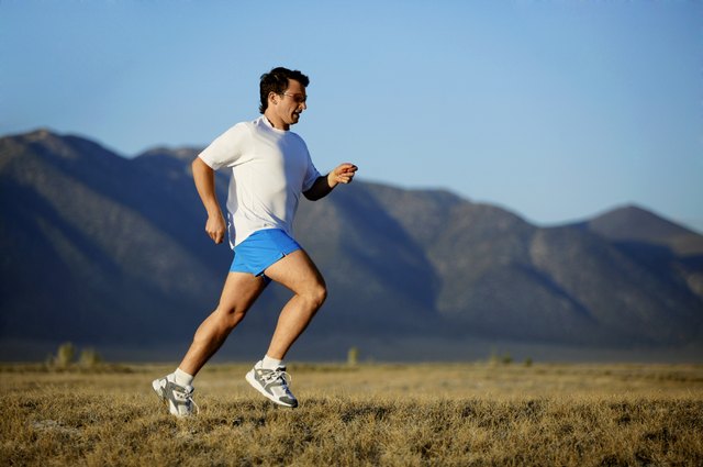 Man running with mountains, California, USA