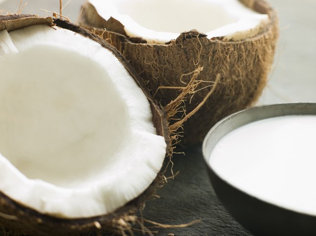 Dish of Coconut Milk with a Split Fresh Coconut